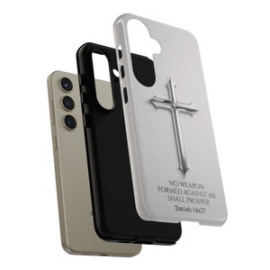 May include: White phone case with a silver cross and the text "No weapon formed against me shall prosper Isaiah 54:17"