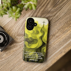 May include: A yellow and black phone case with a cross and a quote from Proverbs 3:5-6: "Trust in the Lord with all your heart and lean not on your own understanding; in all your ways submit to Him, and He will make your paths straight."