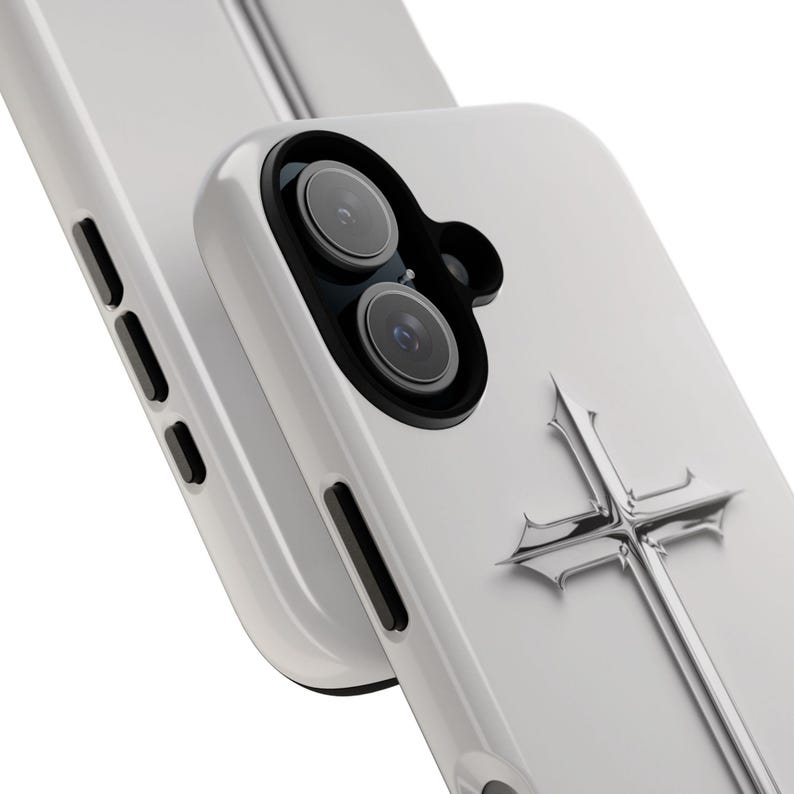 May include: White phone case with a silver cross design. The case has a camera lens cutout and a raised edge around the screen.