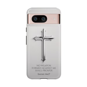 May include: White phone case with a silver cross and the text "NO WEAPON FORMED AGAINST ME SHALL PROSPER Isaiah 54:17"