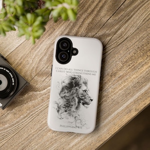 May include: White phone case with a black and white illustration of a lion's head and the text "I can do all things through Christ who strengthens me Philippians 4:13".