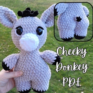 May include: A crocheted gray donkey plush toy with black accents. The toy has large black eyes and a white snout. The text "Cheeky Donkey PDF" is visible in the image.