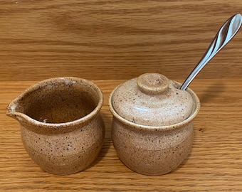 Small pottery cream and sugar set, handmade sugar bowl lid has a spoon rest. Includes matching milk server  or creamer