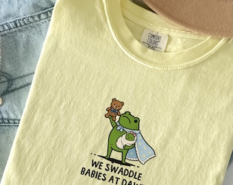 Comfort Colors We Swaddle Babies At Dawn Shirt, Funny NICU Nurse Tshirt, Newborn Nurse Gift, Mother Baby Nurse Frog Tee,Pediatric Nurse Gift