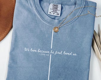 Comfort Colors We Love Because He First Loved Us Shirt, Valentines Christian Love Cross Shirt, Inspirational Women Bible Verse Gift