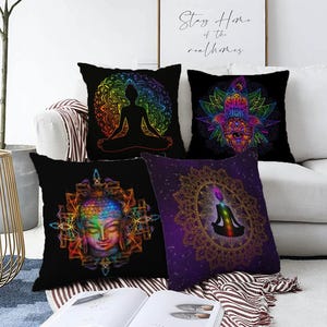 May include: Five black throw pillows with colorful spiritual designs. One pillow features a meditating figure, another a Hamsa hand, a third a Buddha face, and the fourth a meditating figure inside a mandala. The pillows are on a white couch.