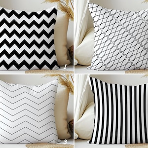 May include: Four decorative throw pillows with different black and white geometric patterns. The patterns include a zigzag, a continuous loop, a chevron, and vertical stripes. The pillows are square and appear to be made of a soft fabric.