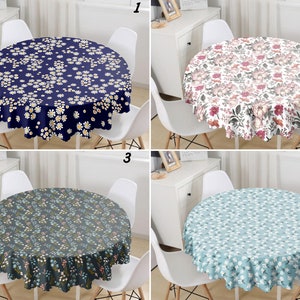 May include: Four round tablecloths with different floral patterns. The tablecloths are in blue, pink, green, and light blue with white flowers. The tablecloths are all on round tables with white chairs.