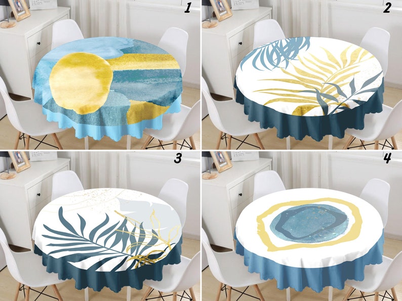 May include: A set of four round tablecloths featuring distinct abstract designs. The first shows a yellow circle on blue and teal layers. The second displays yellow and blue palm leaves. The third features blue palm leaves and gold lines. The fourth has a central blue circle with a yellow border.