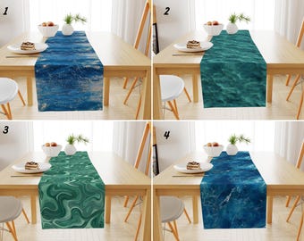 May include: A set of four rectangular table runners featuring distinct water-inspired patterns. Each runner displays a unique print, including deep blue ocean waves, turquoise sea ripples, swirling green marble textures, and dark blue water.