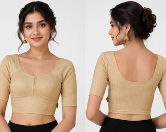 May include: A beige short-sleeved blouse featuring a textured vertical striped pattern, a scoop neckline, and a fitted bodice. The garment is shown from both the front and back views, highlighting the consistent fabric texture and the simple design.