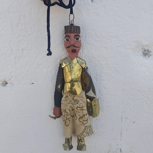 Puppet of Arabian knight from 1950s. Carved wooden body and copper armor