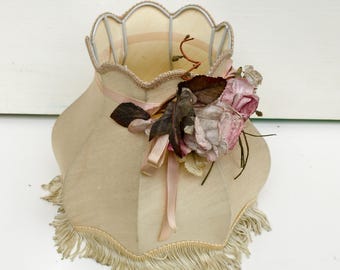 Small fabric fringed lampshade with flowers.