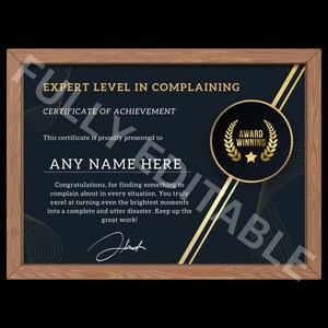 May include: A framed certificate with the text "EXPERT LEVEL IN COMPLAINING" and "AWARD WINNING" in gold. The certificate has a dark blue background with gold accents and a wooden frame. The text "ANY NAME HERE" is also visible.