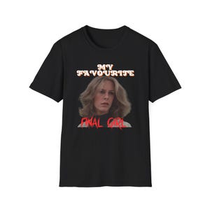 May include: Black t-shirt with a white graphic that says "My Favourite Final Girl" with a picture of Jamie Lee Curtis from the movie Halloween.