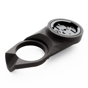 May include: Black plastic bike mount for a cycling computer or GPS device. The mount has a circular opening for the device and a curved arm for attaching to the handlebars.