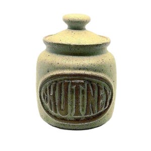 May include: A green ceramic jar with a lid and the word "CHUTNEY" embossed on the front.