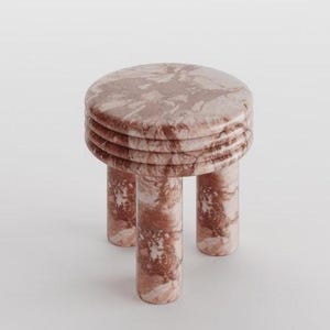 May include: A small, round stool with a marble effect. The stool features a circular top with a stacked, ridged design and three cylindrical legs. The colour is a mix of pink and brown, with a marbled pattern.