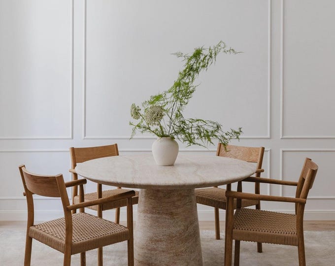 Travertine Round Marble Dining Table is a stunning piece of furniture characterized by its unique and elegant design. Made from high-quality