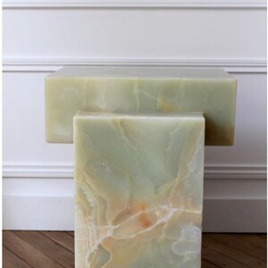 Handcrafted green onyx stone side tables with unique natural mineral patterns.