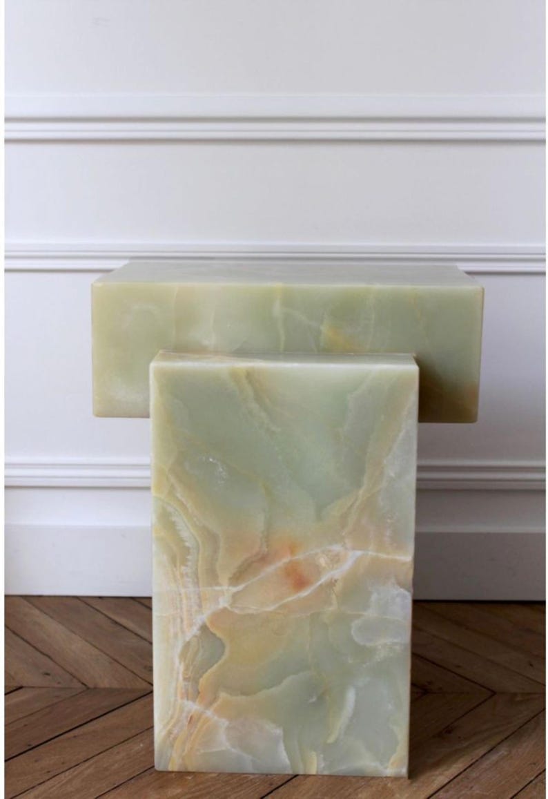 Handcrafted green onyx stone side tables with unique natural mineral patterns.