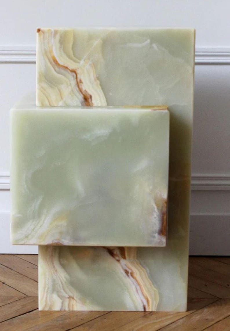 Modern green onyx marble block side tables with natural beige and cream veining.