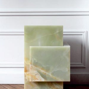 Decorative green onyx cube tables stacked in contemporary living room setting.