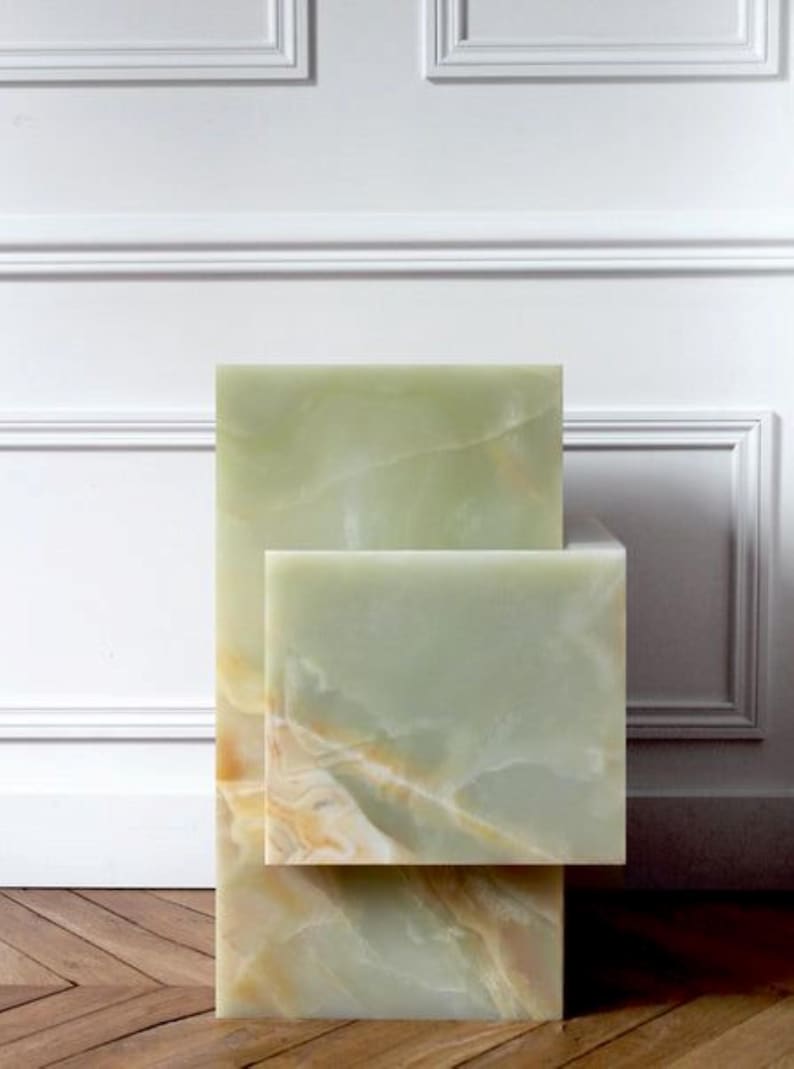 Decorative green onyx cube tables stacked in contemporary living room setting.