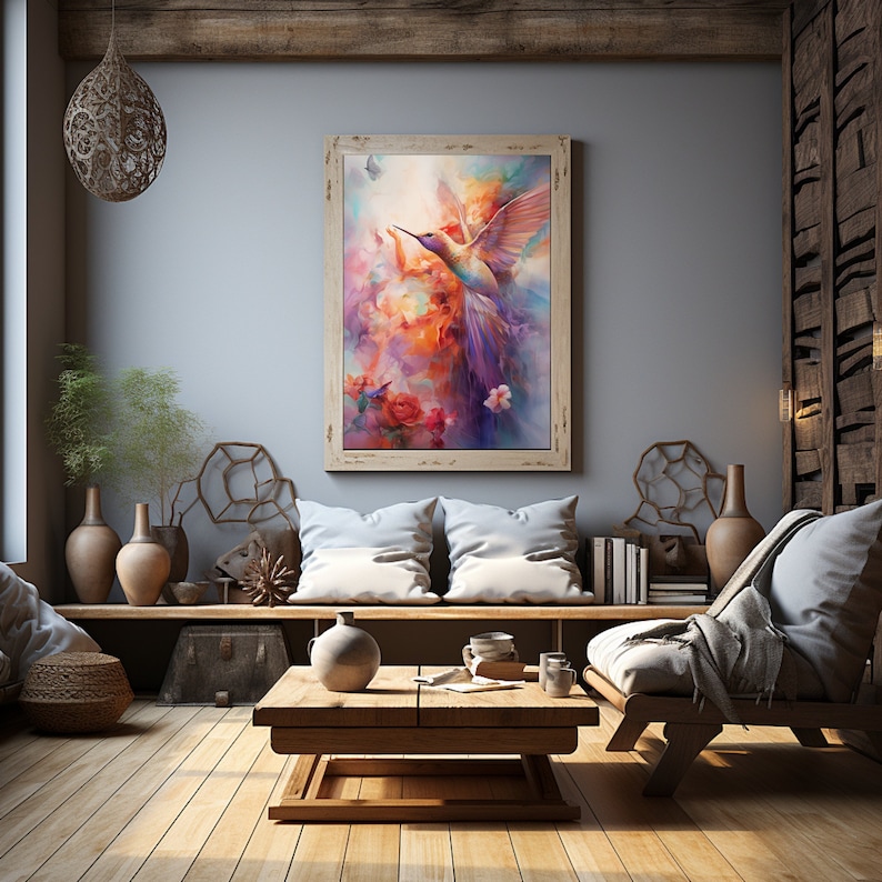 Op de afbeelding: Een ingelijst schilderij van een kleurrijke kolibrie in vlucht tegen een achtergrond van roze, oranje en paarse wolken. De kolibrie wordt omringd door bloemen en een vlinder.