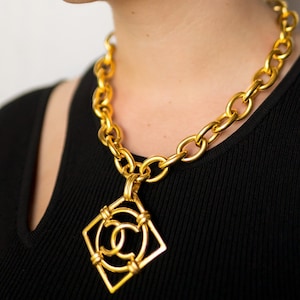 Chanel Vintage Golden Necklace with A Large Cutout Round CC Mark Pendant Top