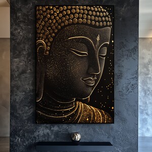 May include: A black and gold Buddha art print. The artwork features a detailed depiction of Buddha's face in profile, with gold accents and a starry background. The image is framed in a black frame and is displayed on a dark gray wall.