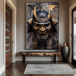 May include: A large, framed artwork featuring a detailed, golden and black samurai mask. The mask is mounted on a textured, abstract background with gold and gray tones. The artwork hangs above a wooden bench in a hallway.