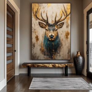 May include: A large canvas print of a deer with large antlers. The deer is looking directly at the viewer. The background is a light brown with gold accents.
