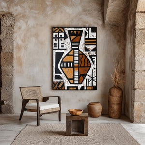 May include: A brown wooden chair with a woven seat and back sits in a room with a beige wall. A black framed painting of a geometric vase with orange and white accents hangs on the wall. A small brown wooden table with a round bowl sits in front of the chair.