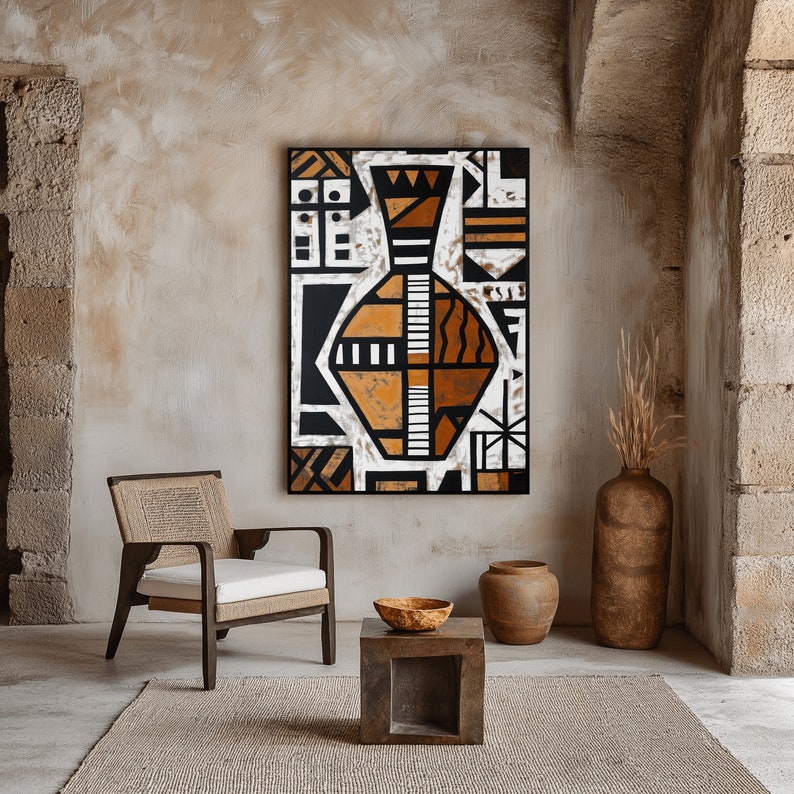 May include: A brown wooden chair with a woven seat and back sits in a room with a beige wall. A black framed painting of a geometric vase with orange and white accents hangs on the wall. A small brown wooden table with a round bowl sits in front of the chair.