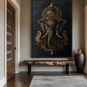 May include: A gold and black framed canvas print of a Hindu deity, Ganesha, with an intricate design. The deity is depicted with an elephant head and a crown.