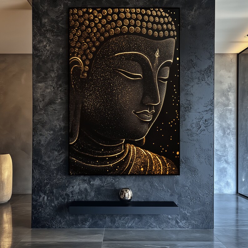 May include: A black and gold Buddha art print. The artwork features a detailed depiction of Buddha's face in profile, with gold accents and a starry background. The image is framed in a black frame and is displayed on a dark gray wall.