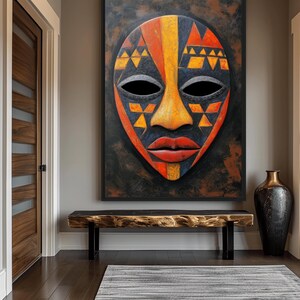 May include: A large, framed African mask with a black background. The mask features a yellow nose, red lips, and a design of orange, yellow, and blue triangles. The mask is hanging above a wooden bench and a decorative vase.
