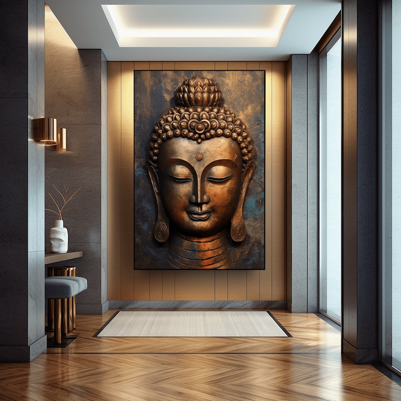 May include: A golden Buddha head sculpture with a serene expression, set against a dark blue background with gold accents. The sculpture is framed and displayed on a wall in a modern interior.