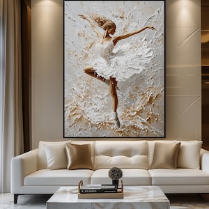 May include: A white canvas painting of a ballerina in a white tutu, dancing on a white background with gold accents. The painting is framed in a black frame.