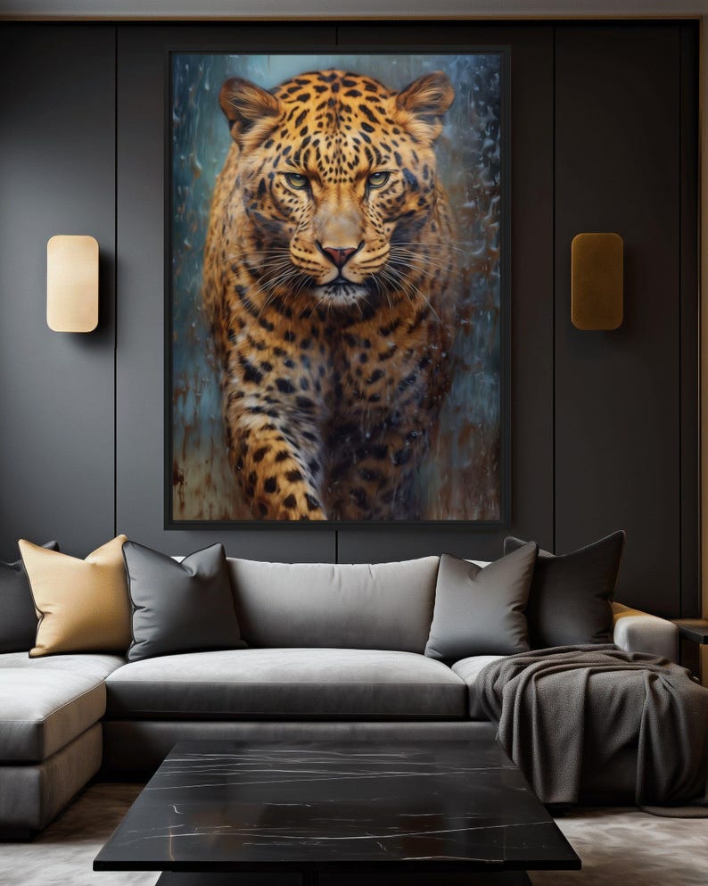 May include: A framed artwork featuring a detailed painting of a leopard. The leopard has a spotted coat in shades of brown and black, with a focused gaze. The artwork is displayed above a gray sectional sofa with decorative pillows.