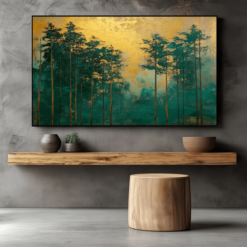 May include: An abstract art piece featuring a forest scene with tall, slender trees in shades of teal and gold. The artwork is framed in black and hangs above a wooden shelf with decorative items. A wooden stool sits below.