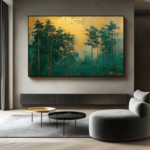 May include: Large rectangular wall art featuring a forest scene. The artwork has a gold background with green and teal trees. The trees have gold trunks and green foliage. The artwork is framed in a black frame.