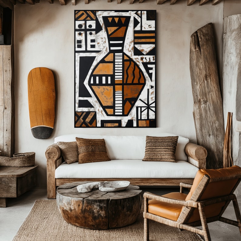 May include: A white couch with brown throw pillows sits in a living room with a wooden coffee table and a brown leather chair. A large abstract painting of a vase with geometric shapes in black, white, and brown hangs on the wall.