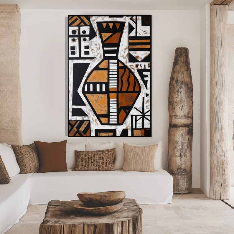May include: Abstract geometric art print featuring a stylized vase in shades of brown, black, and white. The print is framed and hanging on a white wall in a modern living room setting.