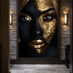 May include: A close-up of a woman's face with black skin and gold glitter makeup. The image is in black and white with a gold overlay.
