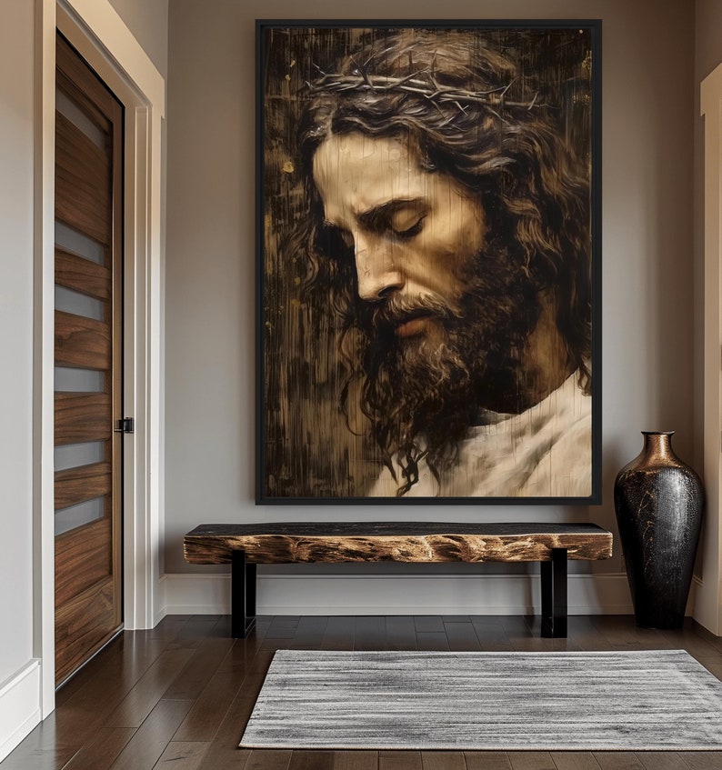 May include: A framed painting of a man with a crown of thorns on his head, looking down with his eyes closed. The painting is in a dark, rustic style and is hanging on a wall in a hallway.