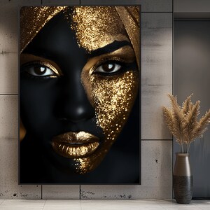 May include: A close-up of a woman's face with black skin and gold glitter makeup. The woman is wearing a gold headscarf.