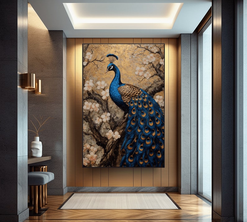 May include: A painting of a peacock with blue and green feathers standing on a branch with white flowers. The background is a gold and brown color.