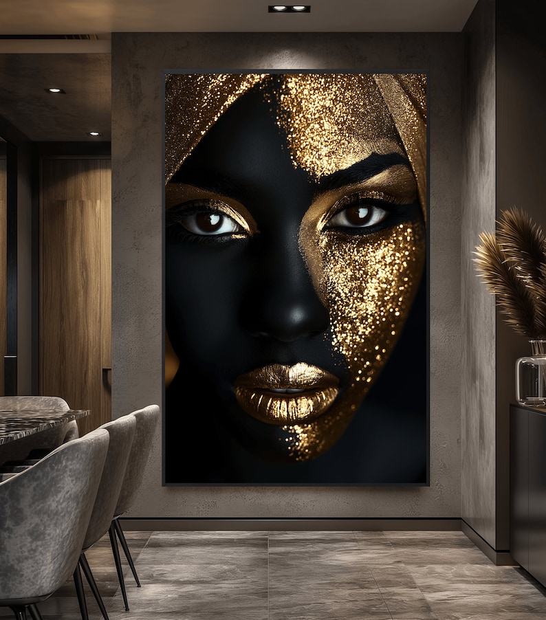 May include: A close-up of a woman's face with black skin and gold glitter makeup. The woman is wearing a gold headscarf. The background is black.